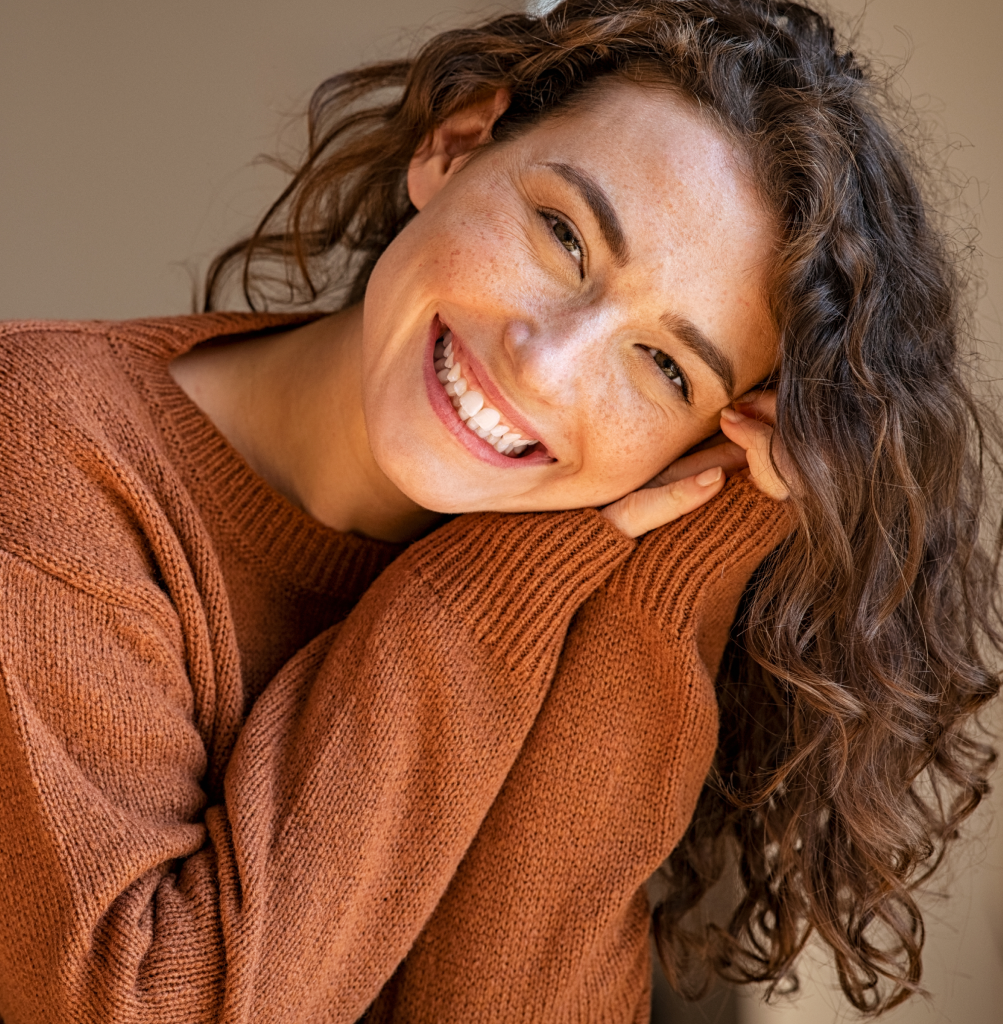 young lady with freckles and straight white teeth